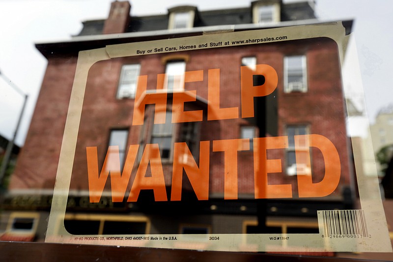 
              FILE - In this Aug. 19, 2013 file photo, a Philadelphia business displays a help wanted sign in its storefront. The Labor Department releases weekly jobless claims on Thursday, April 2, 2015. (AP Photo/Matt Rourke, File)
            