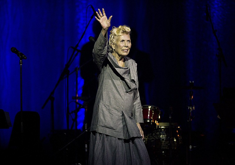 Joni Mitchell waves to the crowd during her 70th birthday tribute concert as part of the Luminato Festival at Massey Hall in Toronto in this June 18, 2013, file photo. Mitchell's website and Twitter account reported Tuesday night March 31, 2015 that she was in the hospital, but gave no details on her condition.