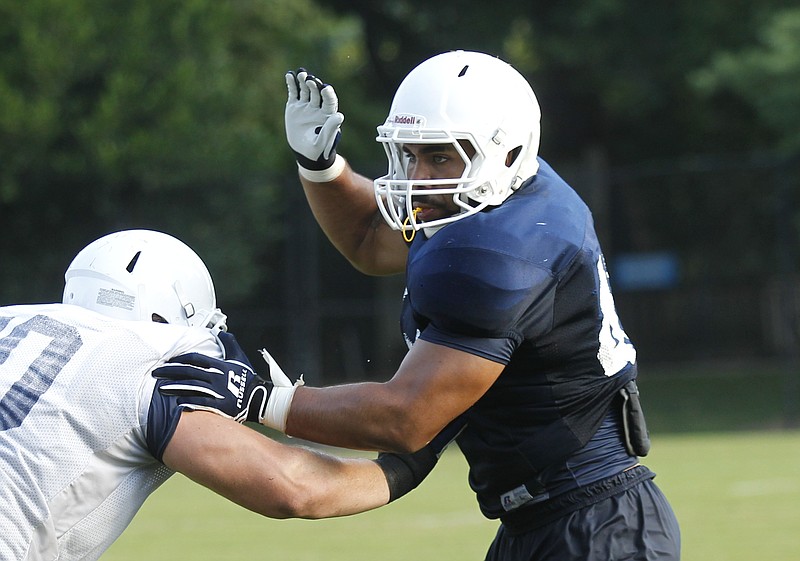UTC linebacker A.J. Hampton deflects an offensive lineman during the Mocs' football practice at Scrappy Moore Field in this  2014 file photo.