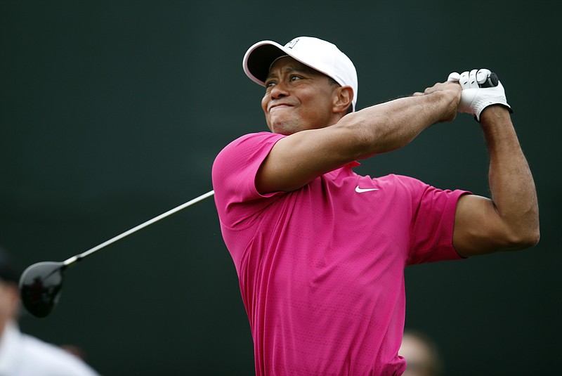 
              FILE - In this Jan. 29, 2015, file photo, Tiger Woods tees off on the 17th hole during the first round of the Phoenix Open golf tournament in Scottsdale, Ariz. Tiger Woods has made up his mind _ he will play the Masters. After two trips to Augusta National this week, Woods announced his return to competition on his website Friday, April 3, 2015. He wrote: "I'm playing the Masters. It's obviously very important to me, and I want to be there."(AP Photo/Rick Scuteri, File)
            