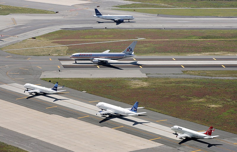 
              FILE - In this Sept. 8, 2008, file photo, planes taxi on runways at John F. Kennedy International Airport in New York. A runway at JFK International will be closed for repairs for five months starting at the end of April 2015, just before New York City’s hectic summer travel season gets underway. (AP Photo/Mark Lennihan, File)
            