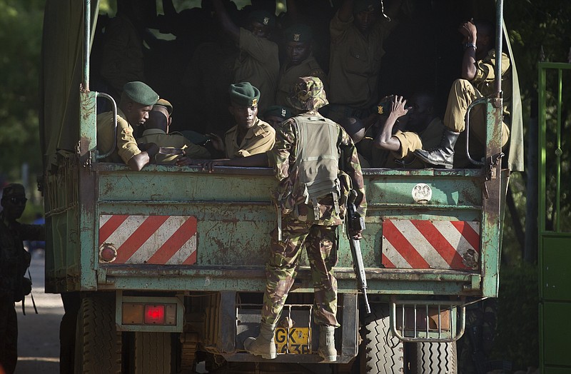 Soldiers from the Kenya Defence Forces enter the college compound in a truck in Garissa, Kenya, on Friday, April 3, 2015.