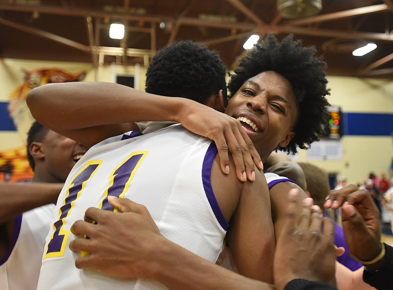 Central's Tre Tiller, right, hugs Ryan Montgomery after defeating Livingston Academy at Chattanooga State Community College on March 3, 2015. 