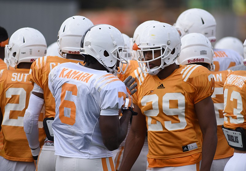 Alvin Kamara, left, talks with Evan Berry during practice March 31, 2015, at Haslam Field in Knoxville.