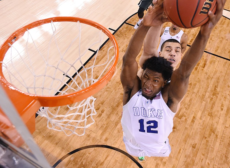 
              Duke's Justise Winslow (12) is fouled by Michigan State's Gavin Schilling, rear, during the second half of the NCAA Final Four tournament college basketball semifinal game Saturday, April 4, 2015, in Indianapolis. (AP Photo/Chris Steppig, Pool)
            