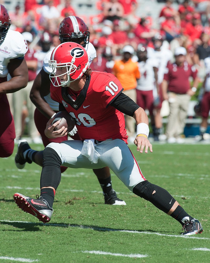 Georgia redshirt junior quarterback Faton Bauta, shown rushing last year against Troy, is competing this spring with redshirt sophomore Brice Ramsey and redshirt freshman Jacob Park for the starting job.