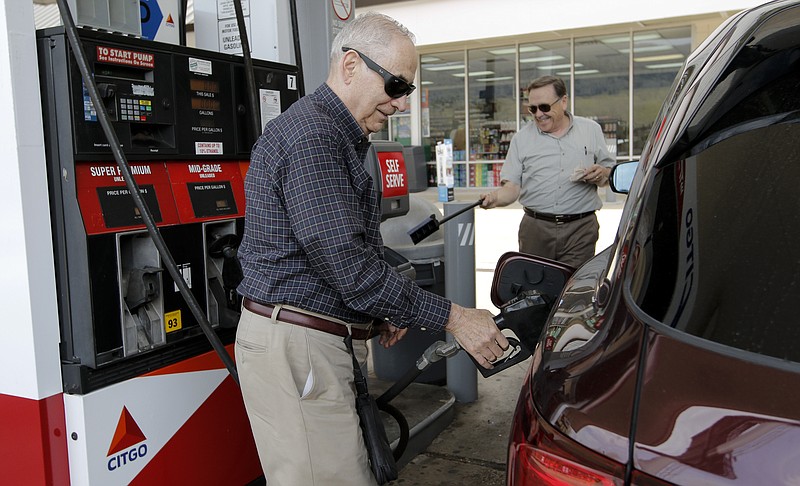 George Loga fills up his gas tank Friday at Citgo off interstate 24 exit 169 in Dade County, Ga. Loga was traveling home to Chicago from vacation and said he always stops at this exit because gas is cheaper, but if prices go up he says there won't be a compelling reason to choose this exit over a more convenient spot. The Georgia Legislature has passed a bill that will boost gas prices throughout the state, and Dade County expects to be hurt worse than others.