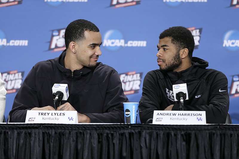 Kentucky's Trey Lyles, left, talks with teammate Andrew Harrison, right, during a news conference on April 3, 2015, in Indianapolis.