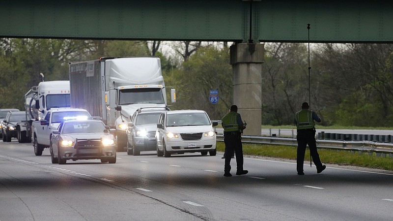 
              Investigators work in I-85 at the scene where three people died early Monday, April 6, 2015, when a van carrying members of two heavy metal bands crashed near the town of Commerce, Ga., about 65 miles northeast of Atlanta, according to authorities. Members of the Atlanta-based band, "Khaotika, " and the Huntsville, Ala.-based band, "Wormreich, " were in the van. Georgia State Patrol Cpl. Scott Smith said the driver of the 15-passenger van "apparently fell asleep and allowed the vehicle to leave the roadway, at which time the vehicle struck a tree on the passenger side."  (AP Photo/Atlanta Journal-Constitution, Bob Andres)  MARIETTA DAILY OUT; GWINNETT DAILY POST OUT; LOCAL TELEVISION OUT; WXIA-TV OUT; WGCL-TV OUT
            