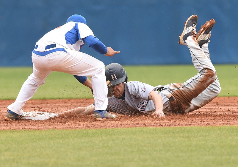 Heritage's Harrison Horsley slides face first into the glove of Northwest Whitfield's Omar Hernandez at second base during Tuesday's Region 7-AAAA baseball game. The Bruins won 6-5, at home.