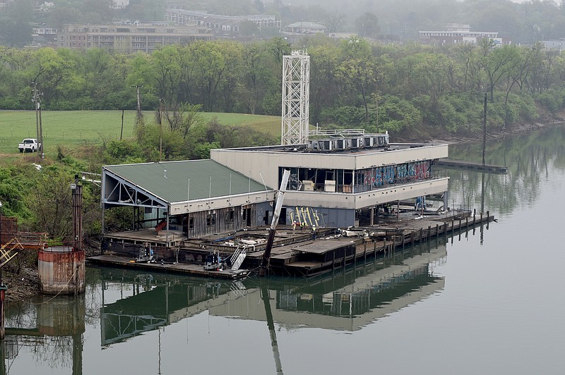 The first floor of the Casey barge is seen above water Tuesday, Apr. 7, 2015, in Chattanooga, Tenn., after several days of pumping water from the troubled former floating restaurant.