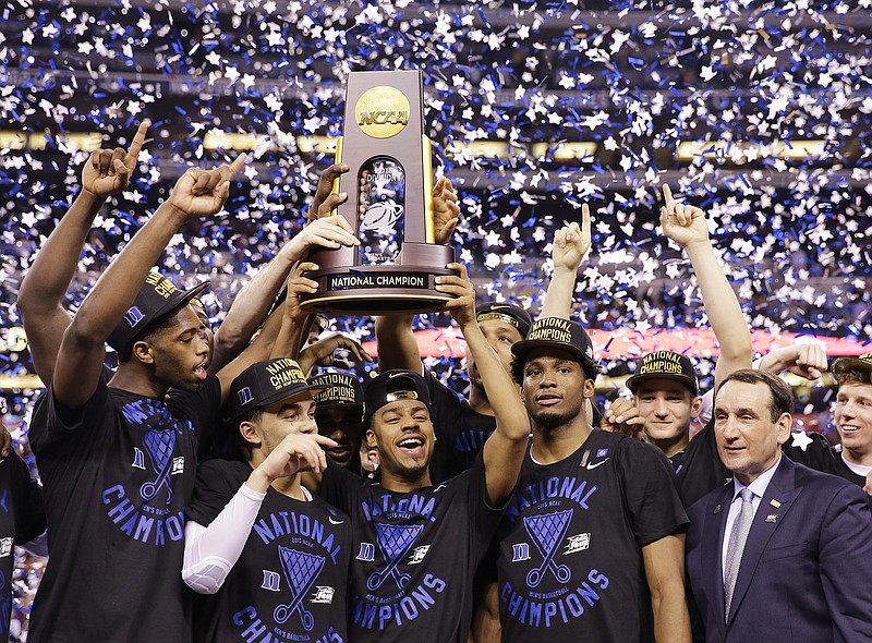 Duke players celebrate with the trophy after their 68-63 victory over Wisconsin in the NCAA Final Four college basketball tournament championship game Monday, April 6, 2015, in Indianapolis.