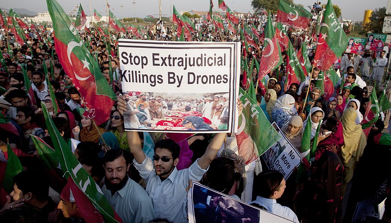 In this Friday, Oct 28, 2011, file photo, supporters of Pakistani cricketer-turned-politician Imran Khan rally in Islamabad, Pakistan, to condemn U. S. drone attacks in Pakistani tribal areas on al-Qaida and Taliban hideouts.
