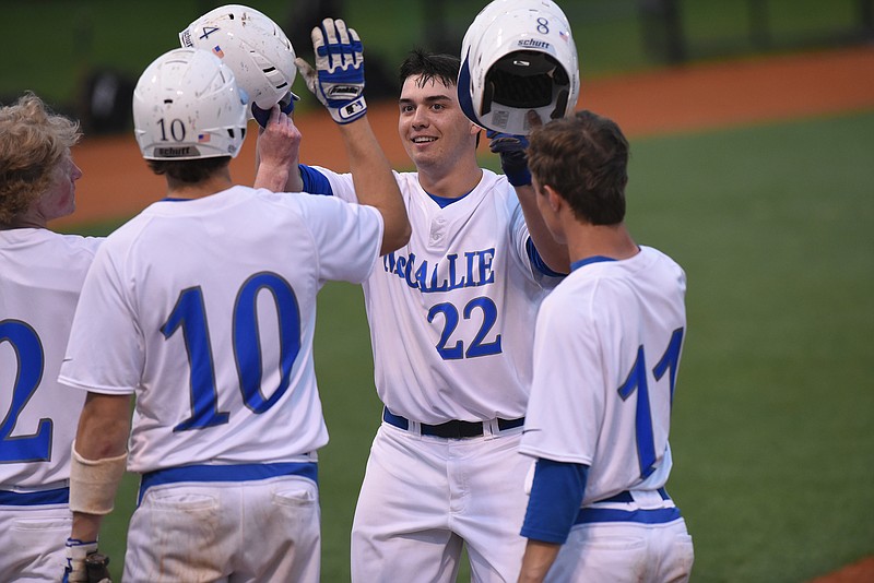 McCallie first baseman Ethan Cady (22) gets a warm welcome at the plate from teammates William Korn (2), Quinn Smith (10) and Tyler Payne (11) after a 3-run dinger in the bottom of the second inning Tuesday to put the Blue Tornados up 6-0, over Bradley Central  at home. 
