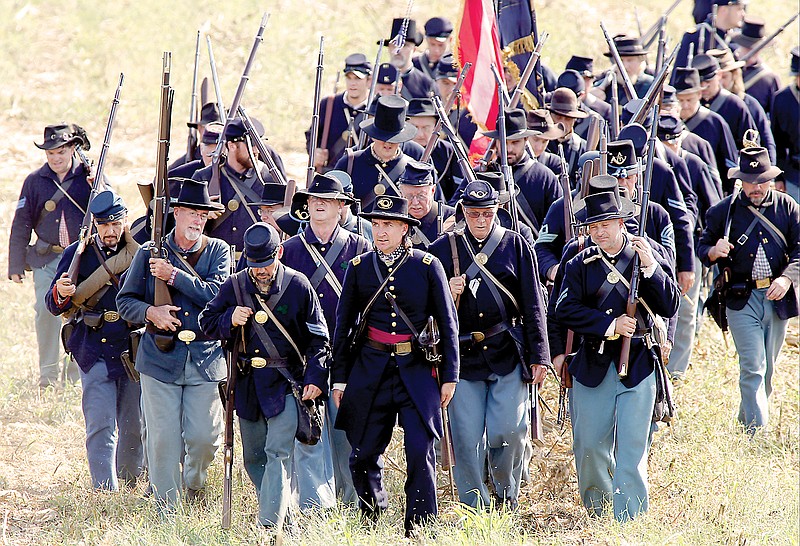 Re-enactors dressed as Union soldiers march during a combined re-enactment of the Battle of Reed's Bridge and the Battle of Alexander's Bridge in September 2013 in Chickamauga, Ga. The 150th anniversary of the end of the Civil War is observed today.