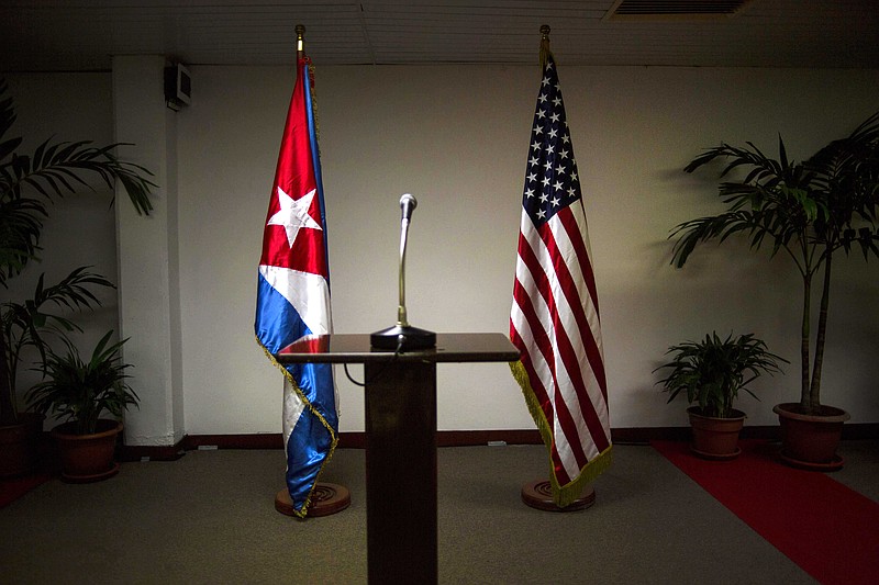 
              FILE - In this Jan. 22, 2015 file photo, a Cuban and U.S. flag stand before the start of a press conference on the sidelines of talks between the two nations in Havana, Cuba. The U.S. hopes to open an embassy in Havana before presidents Barack Obama and Raul Castro meet at a regional summit in April, which will be the scene of the presidents’ first face-to-face meeting since they announced on Dec. 17 that they will re-establish diplomatic relations after a half-century of hostility. (AP Photo/Ramon Espinosa, File)
            
