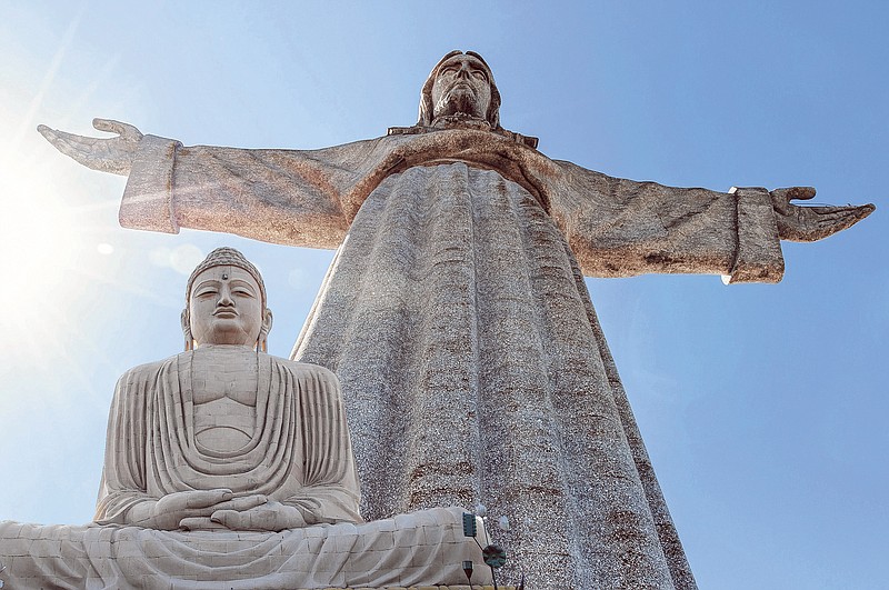 Images of statues depicting Jesus Christ and Gautama Buddha are combined together in this photo illustration.