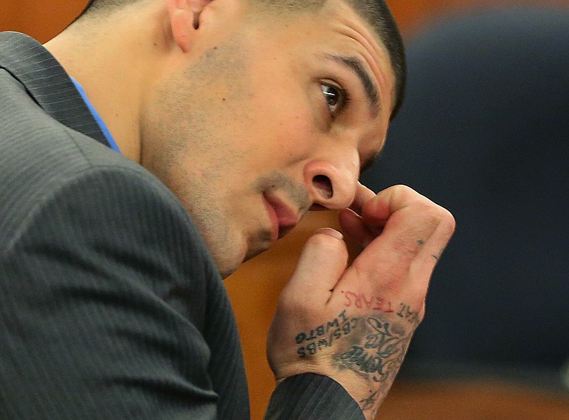 
              Former New England Patriots football player Aaron Hernandez wipes his face as he listens to the judge instruct the jury during his trial in Fall River, Mass., Tuesday, April 7, 2015.  Hernandez is accused of killing Odin Lloyd in June 2013.  (AP Photo/The Boston Globe, John Tlumacki, Pool)
            