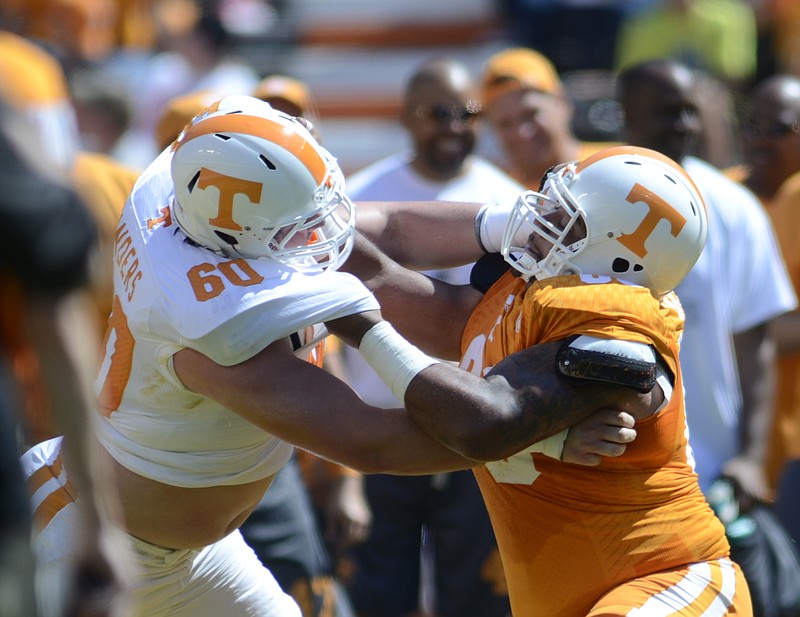 Former Bradley Central player, Austin Sanders (60) goes up against Allan Carson during an exhibition drill in the spring Orange and White game Saturday at Neyland Stadium in this 2014 file photo.