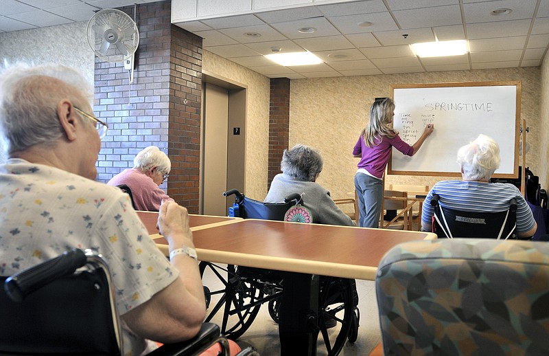 
              FILE - In this Feb. 28, 2013, file photo, Tina Reese leads a word game for residents at a nursing home in Lancaster, Pa. The cost of staying in a nursing home has increased 4 percent every year over the last five years, according to Genworth Financial's annual “Cost of Care” report, released Thursday, April 9, 2015. Last year, the median bill was $87,600. (AP Photo/Intelligencer Journal, Dan Marschka, File)
            