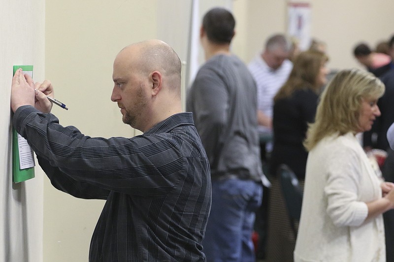 
              In this April 2, 2015 photo, Daniel Marquardt from LaFayette, Ga., fills out an application during a huge 15-county job fair in Ringgold, Ga. The Labor Department releases weekly jobless claims on Thursday, April 9, 2015. (AP Photo/Chattanooga Times Free Press, Dan Henry) THE DAILY CITIZEN OUT; NOOGA.COM OUT; CLEVELAND DAILY BANNER OUT; LOCAL INTERNET OUT
            