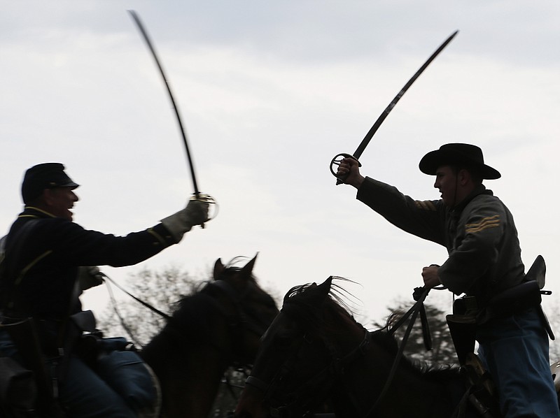 
              Confederate and Union forces clash during a re-enactment of the Battle of Appomattox Station, Wednesday, April 8, 2015, as part of the 150th anniversary of the surrender of the Army of Northern Virginia to Union forces at Appomattox Court House, in Appomattox, Va. (AP Photo/Steve Helber)
            