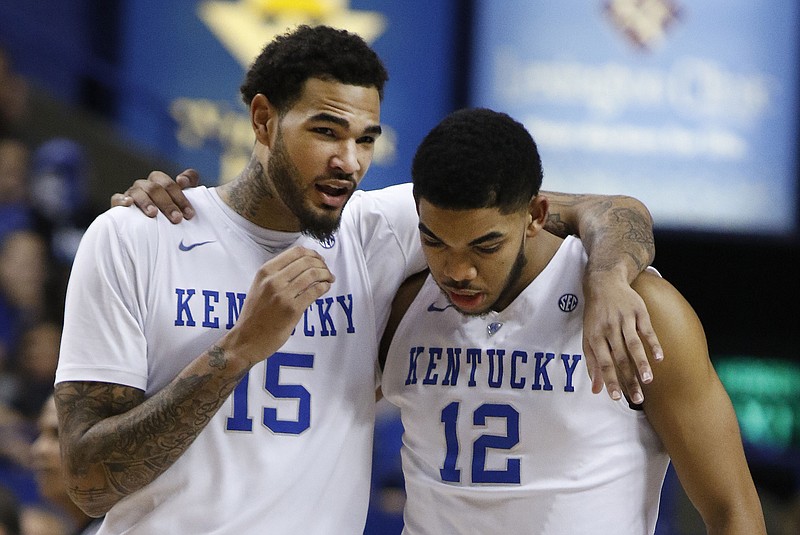 Kentucky's Willie Cauley-Stein (15) talks to teammate Karl-Anthony Towns (12) during a time-out in the first half of an NCAA college basketball game against Alabama on Saturday, Jan. 31, 2015, in Lexington, Ky. Kentucky won 70-55.