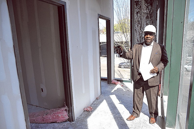 Cordell Carter, CEO of TechTown, points out video editing rooms on a tour of the facility.