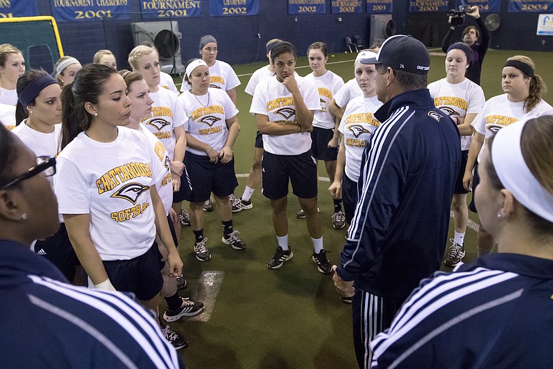 UTC softball players gather around coach Frank Reed before beginning practice at their hitting facility in Chattanooga
on , Jan. 28, 2015.