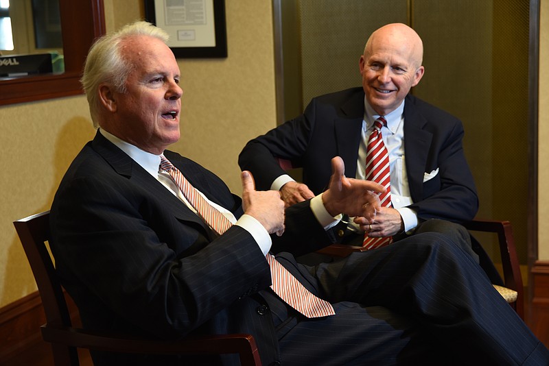 Pinnacle Bank CEO M. Terry Turner, left, and Capital Bank CEO R. Craig Holley talk about the merger of the two entities in the executive offices at 801 Broad St. on April 8, 2015. 