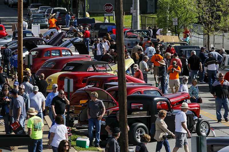 People walk along lines of parked cars Saturday, April 11, 2015, at the Chattanooga Cruise-In. The annual cruise-in drew classic and collector car owners and enthusiasts to Coker Tire and the surrounding areas for Chattanooga's largest car show.