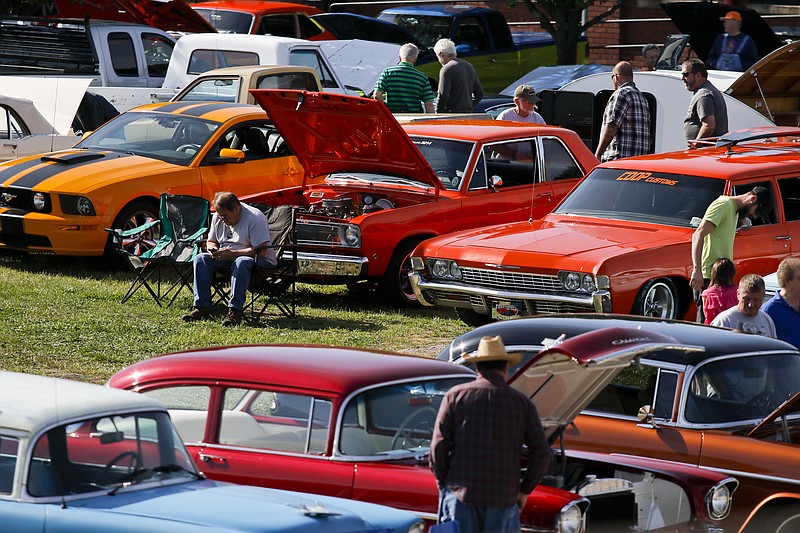 People walk among lines of parked cars Saturday, April 11, 2015, at the Chattanooga Cruise-In. The annual cruise-in drew classic and collector car owners and enthusiasts to Coker Tire and the surrounding areas for Chattanooga's largest car show.