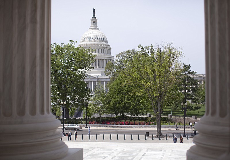 The Capitol building is seen through the columns on the steps of the Supreme Court in Washington in this May 5, 2014, file photo.