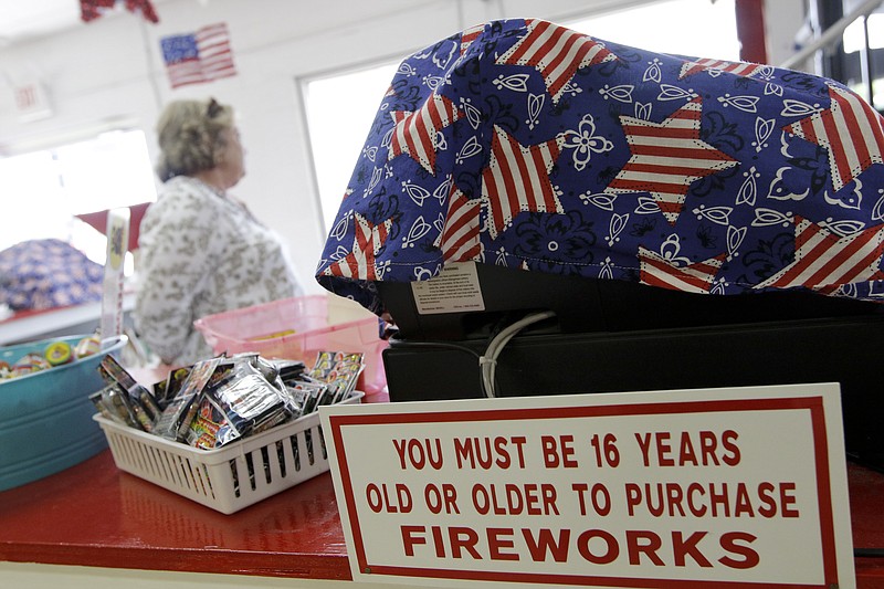 A sign stating the legal age of purchase is displayed at Dixieland Fireworks in East Ridge on April 11, 2015.