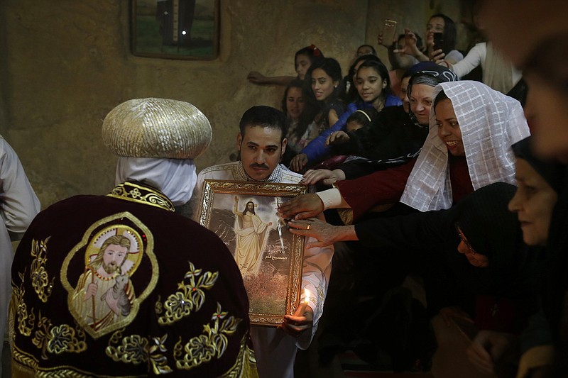 
              Egyptian Coptic Christian pray during the Easter Eve service at St. Sama'ans Church in the Mokattam district of Cairo, Egypt, Saturday, April 11, 2015. (AP Photo/Hassan Ammar)
            
