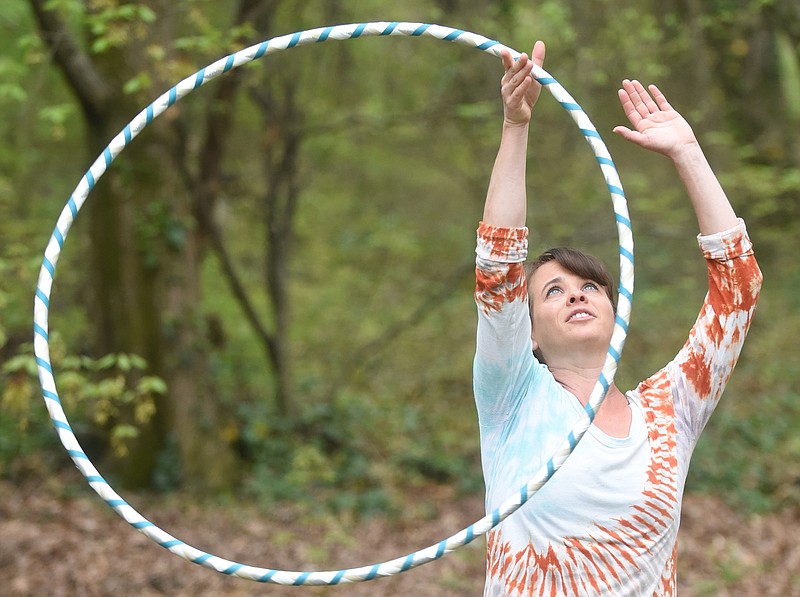 Julie Whitehead uses a hula hoop in her Brainerd yard to get a good workout.