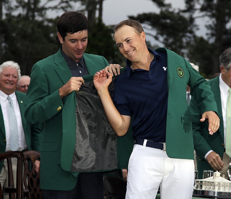 
              Bubba Watson helps Jordan Spieth put on his green jacket after winning the Masters golf tournament Sunday, April 12, 2015, in Augusta, Ga. (AP Photo/Matt Slocum)
            