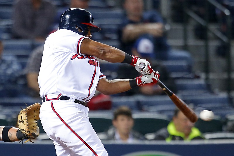 Atlanta Braves Alberto Callaspo (1) hits a single to bring in Atlanta Braves Jace Peterson in the fifth inning of a baseball game against the Miami Marlins on Monday, April 13, 2015, in Atlanta. 