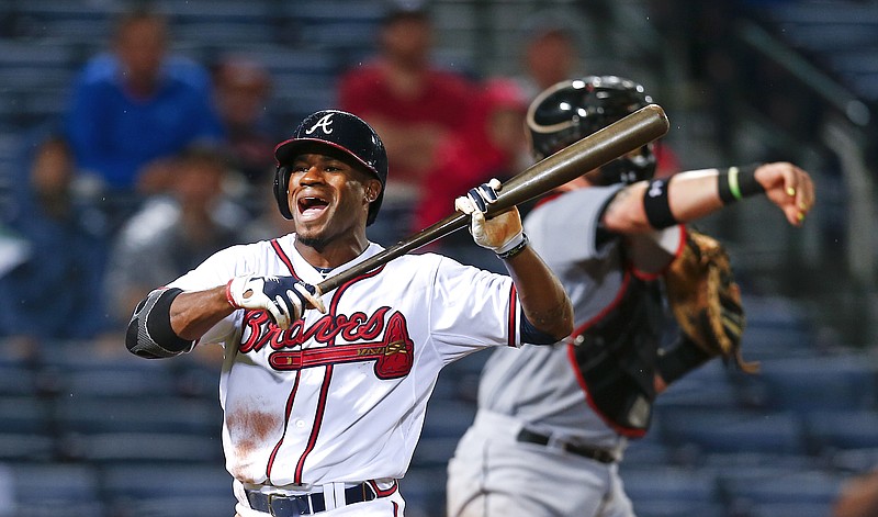 Atlanta Braves' Eric Young Jr. (4) reacts after a called third strike in the seventh inning of a Major League baseball game against the Miami Marlins Tuesday, April 14, 2015, in Atlanta.