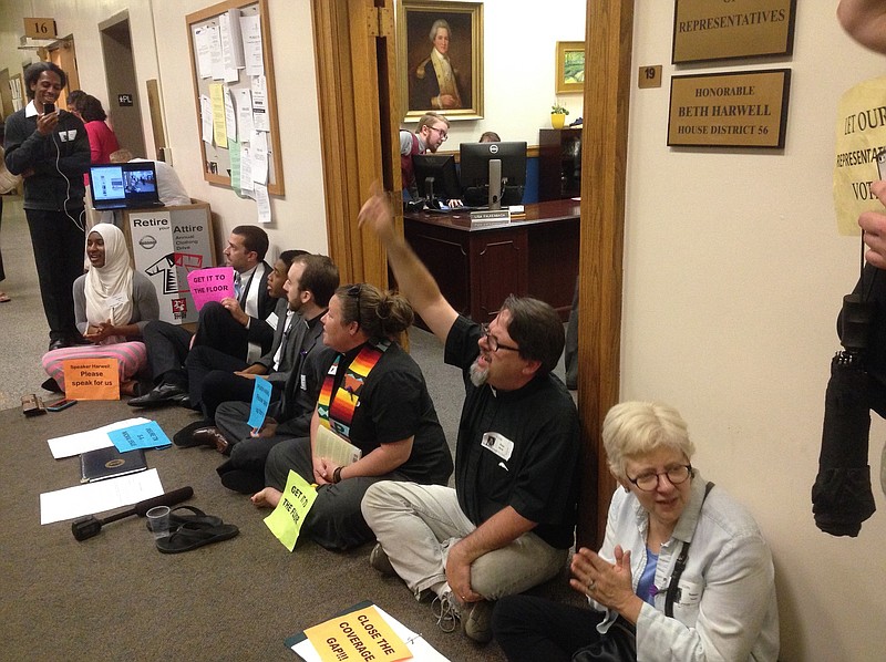 The Rev. Brian Merritt of Chattannoga (second from right) leads demonstrators in sit-down protest in favor of Insure Tennessee. 