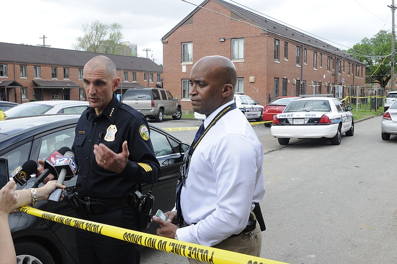 Chattanooga Police Chief Fred Fletcher, left, and Lt. Glenn Scruggs answers questions from the media Wednesday afternoon following a suspected homicide in the building directly behind them in College Hill Courts in  this file photo.