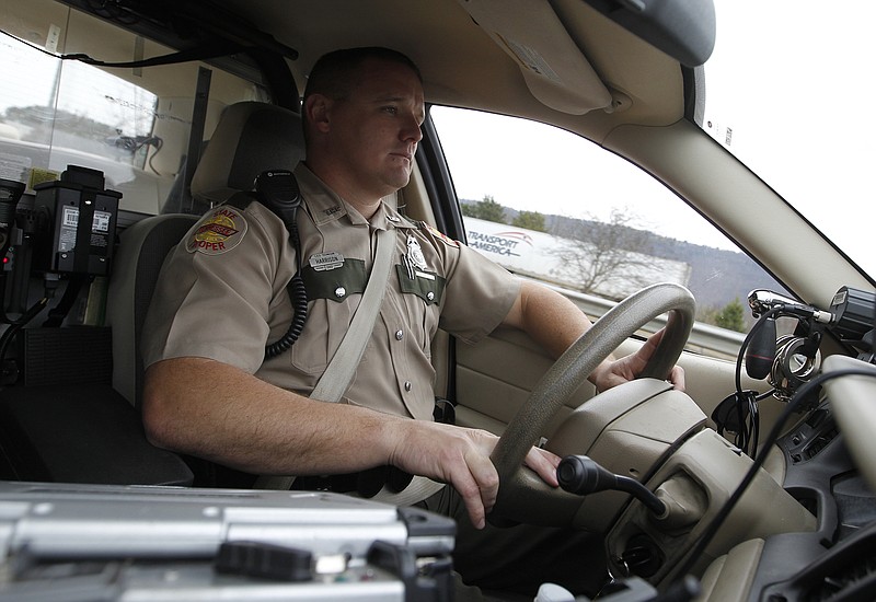 Tennessee state trooper Ben Harrison searches for seat belt violations from his cruiser Monday, Nov. 25, 2013, along Interstate 24 west of Chattanooga.
