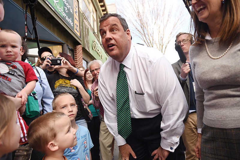 New Jersey Gov. Chris Christie shakes hands with young Manchester residents while greeting people who were waiting for free ice cream cones from Ben & Jerry's in Manchester, N.H., on April 14, 2015. (Tyson Trish/The Record of Bergen County via AP)
