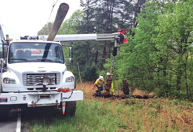 Utility crews work to replace a utility pole the scene of a fatal accident on Burkhalter Gap Road on Lookout Mountain.