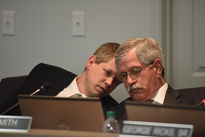 Dr. Jonathan Welch, left, speaks to Superintendent Rick Smith during the Hamilton County School Board meeting in this file photo.