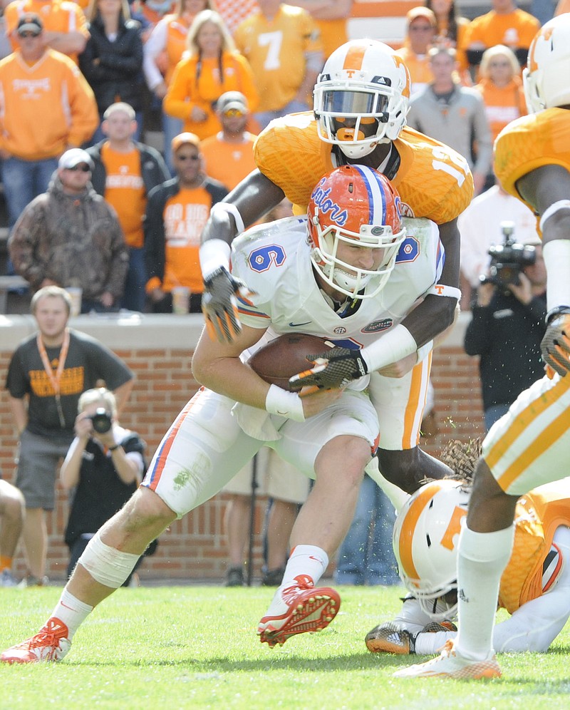 Tennessee's Emmanuel Moseley (12) comes over the top of Florida's Jeff Driskel (6) late in this Oct. 4, 2014, file photo.