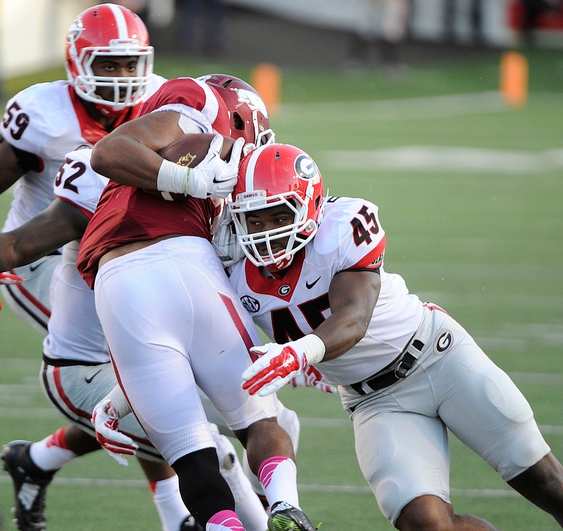 Linebacker Reggie Carter makes a tackle during Georgia's game with Arkansas in this Oct. 18, 2014, file photo.
