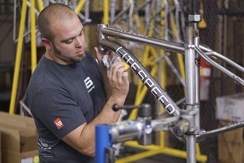 Don Burton applies decals to a finished Litespeed mountain bike while at the American Bicycle Group headquarters in Collegedale, Tennessee, in this Nov. 11, 2014, file photo.