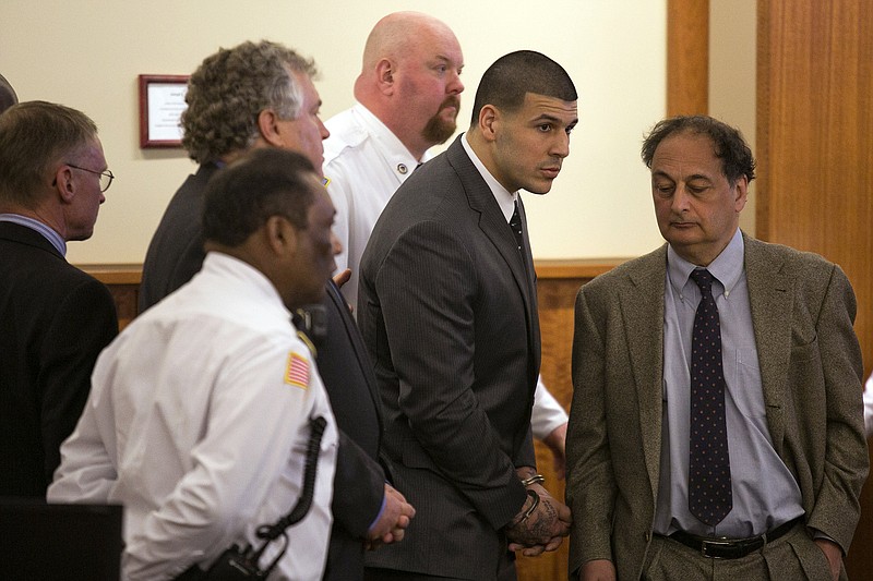 
              Former New England Patriots football player Aaron Hernandez stands up after he is sentenced to life in prison at his murder trial at the Bristol County Superior Court in Fall River, Mass., on Wednesday, April 15, 2015.  Hernandez was found guilty of first-degree murder in the shooting death of Odin Lloyd in June 2013.   (Dominick Reuter/Pool Photo via AP)
            