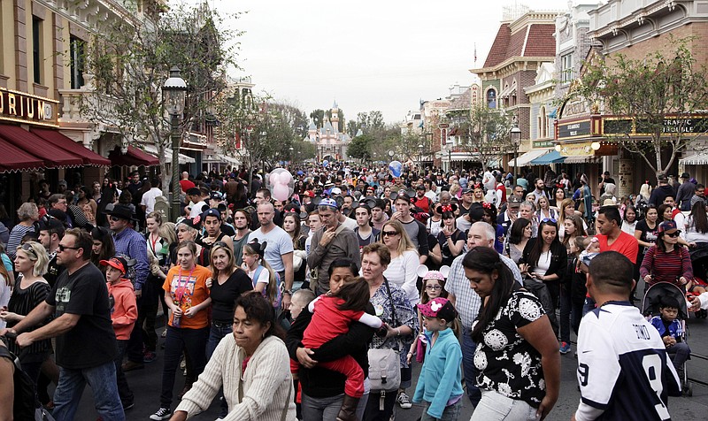 
              FILE - In this Jan. 22, 2015, file photo, people crowd Main Street at Disneyland in Anaheim, Calif. California health officials have declared an end to the large measles outbreak that originated at Disneyland in December. (AP Photo/Jae C. Hong, File)
            